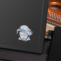 Black grand piano lid with Beethoven inlay, strings visible inside.