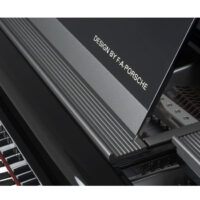 Close-up of F.A. Porsche designed grand piano lid and strings in a polished black finish.
