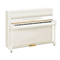 White Yamaha upright piano with gold pedals.