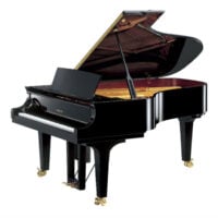 Yamaha grand piano with polished black finish, open lid, and brass casters.