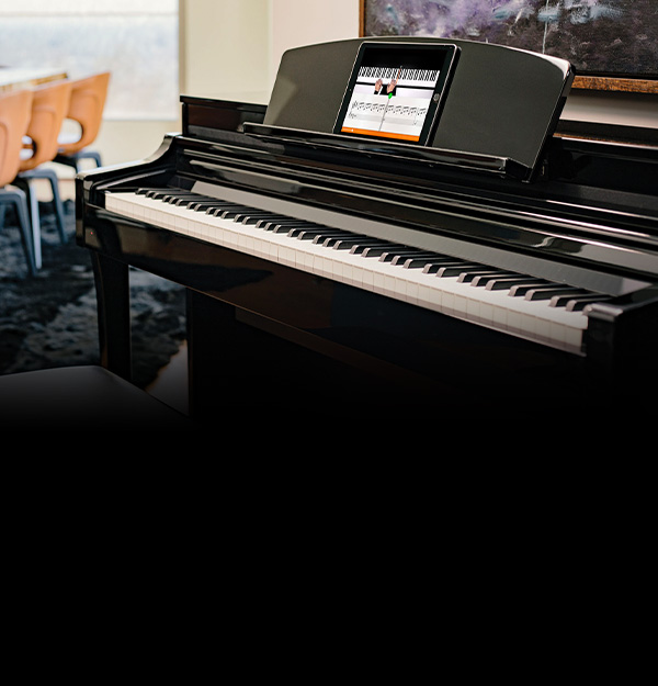 Digital piano with glossy black finish and integrated display, highlighting advanced features at Classic Pianos Reno.