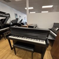 Yamaha digital piano with sleek black finish and matching bench, showcasing high-quality keys for optimal performance.