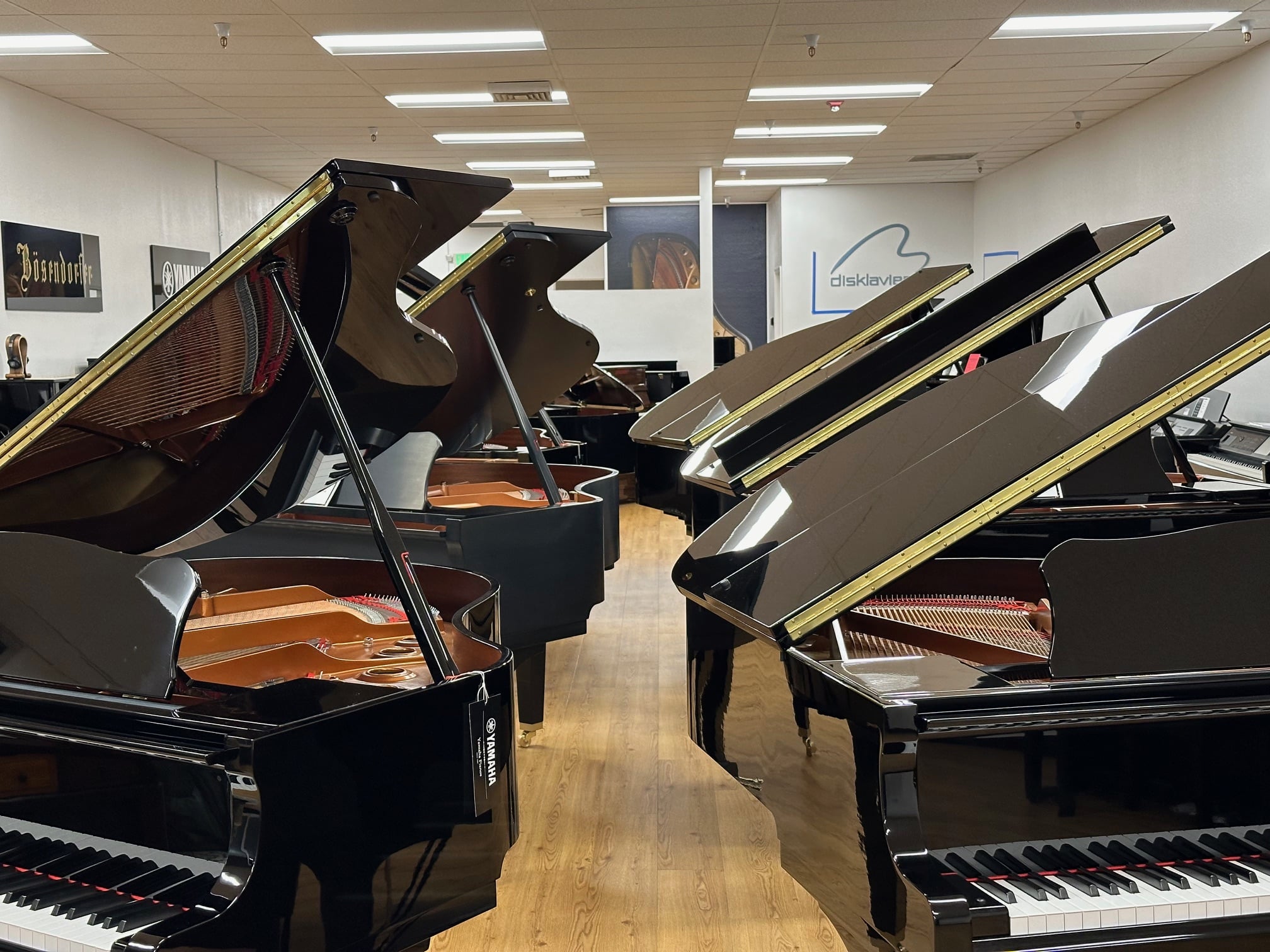 Elegant grand pianos on display, featuring premium finishes, including Yamaha and Bösendorfer models, at Classic Pianos Reno.