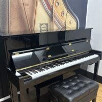 Elegant Kawai piano in polished black finish, featuring a versatile keyboard and comfortable padded bench for musicians.