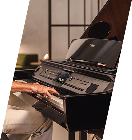 Person playing a Casio grand hybrid piano in a modern living space.